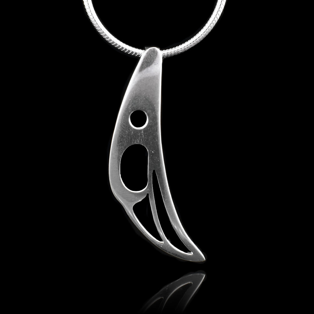 This sterling silver pendant has a minimalist design; it is shaped like and has cutouts that depict the Raven.
