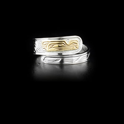 This gold and silver ring is made from sterling silver and 14K gold and has carvings that depict the Wolf on it. The tapered band wraps around the finger twice. The head of the Wolf is made from 14K gold.