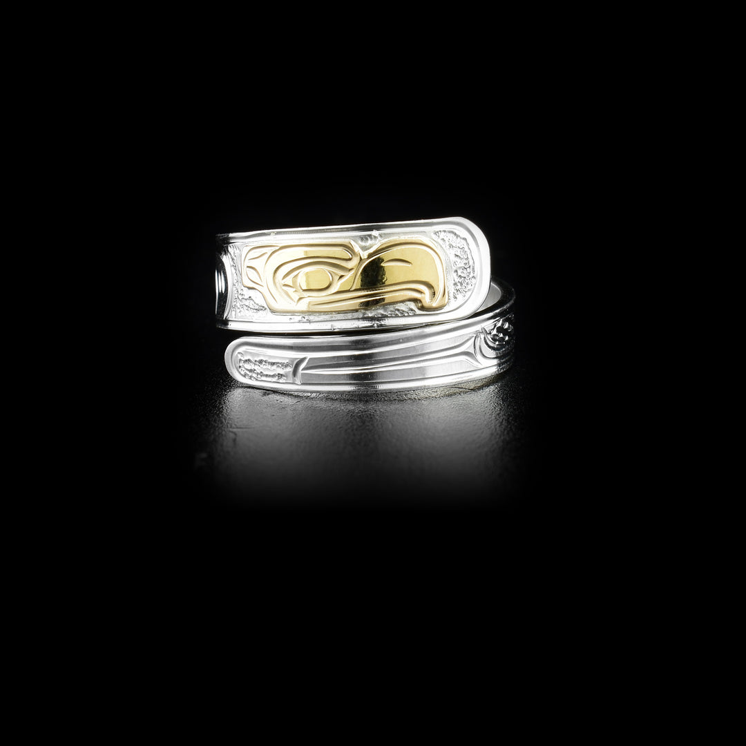 This sterling silver wrap around ring has carvings that depict the Eagle and the band wraps around the finger twice. The head of the eagle is made form 14K gold. 