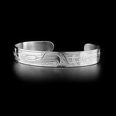 This sterling silver cuff bracelet has a thin band with a depiction of the Eagle carved into the surface of it.