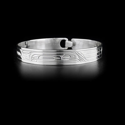 This sterling silver clasp bracelet has a depiction of the Raven carved around it. There is a built in clasp in the back.