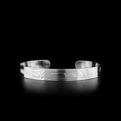 This sterling silver cuff bracelet has a depiction of the Raven carved into the surface of the band.