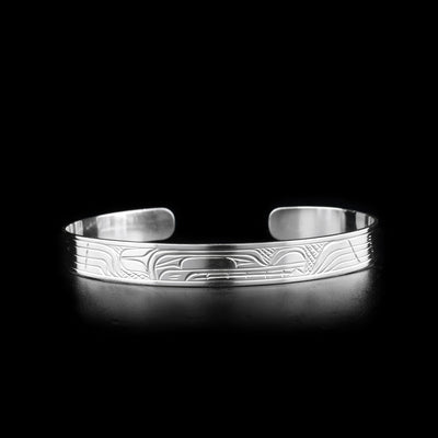 This sterling silver cuff bracelet has a depiction of the Wolf carved into the surface of the band.