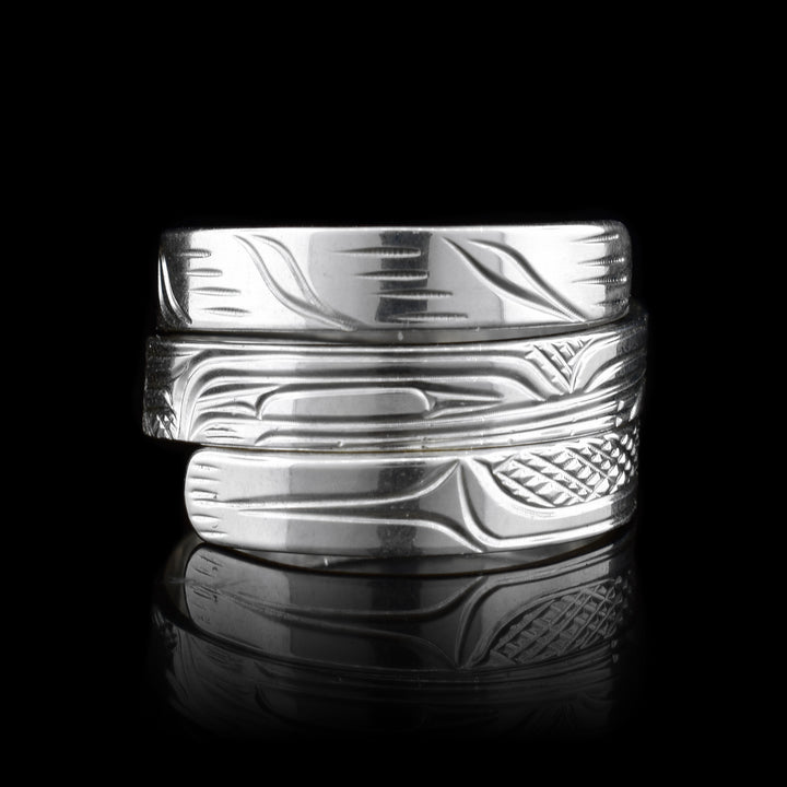 This Wolf ring is made from sterling silver and has a single, thin band that wraps around the finger three times. There is a depiction of the Wolf carved into the surface of the band.