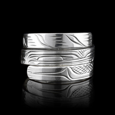 This Wolf ring is made from sterling silver and has a single, thin band that wraps around the finger three times. There is a depiction of the Wolf carved into the surface of the band.