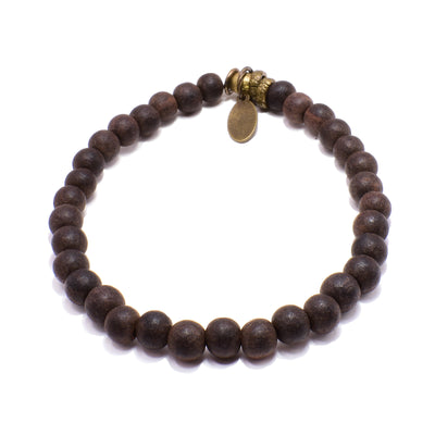 This wooden bead bracelet has a brass tassel and clasp. There are small, circular, and wooden beads around the entire bracelet.