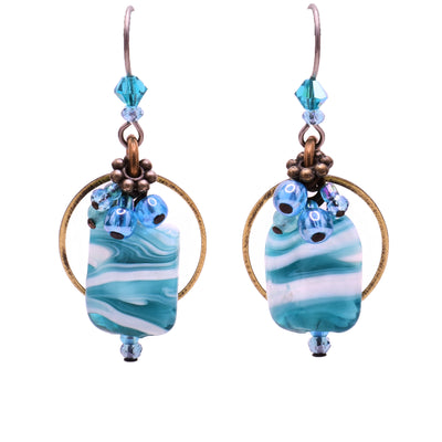 Dangle earrings made of Swarovski crystal, lampworked glass, handworked brass and glass. Titanium hooks. By Honica.