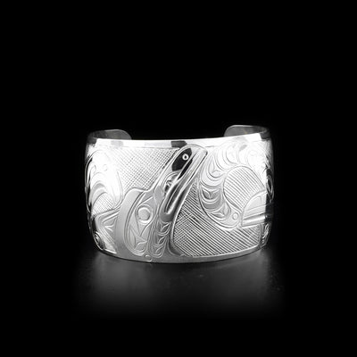 Sterling silver 1.5” wide cuff bracelet depicting scene of two thunderbirds feeding their baby.