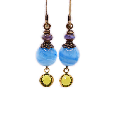 Brass dangle earrings with blue handmade lampworked glass beads and crystals.