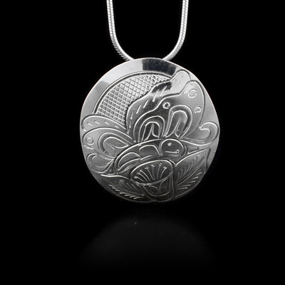 This sterling silver pendant has a circular shape and has a butterfly and flower carved into it