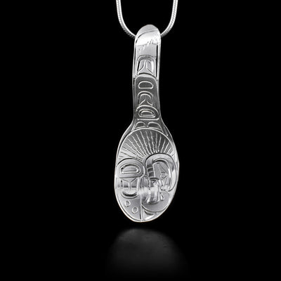 This sterling silver pendant is shaped like a spoon and is attached by the end of the spoon's handle. There are also engravings that depict the Eagle on it.