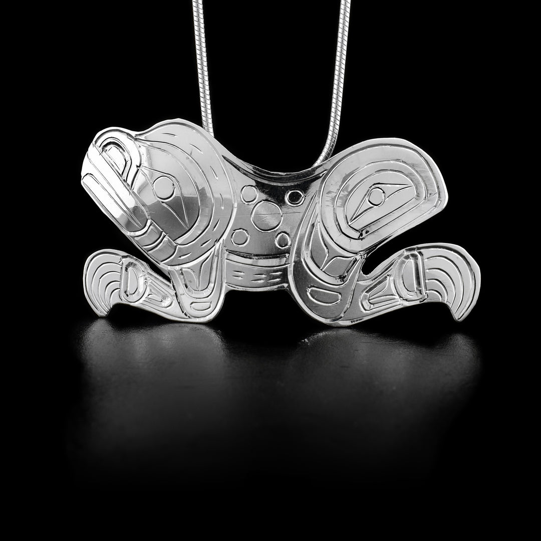 This sterling silver Frog pendant is shaped like the Frog and has patterns carved into it to depict the Frog