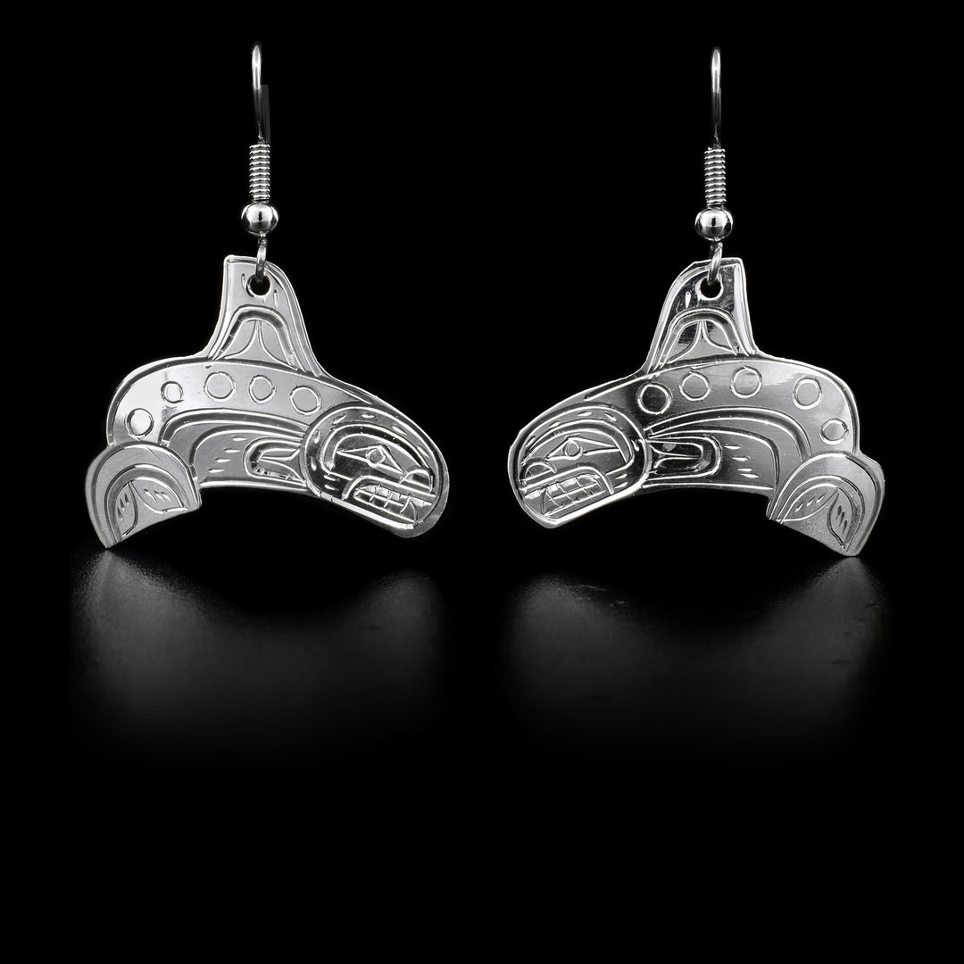 These dangling sterling silver Orca earrings have hangs that are shaped like and has carvings that depict the Orca.