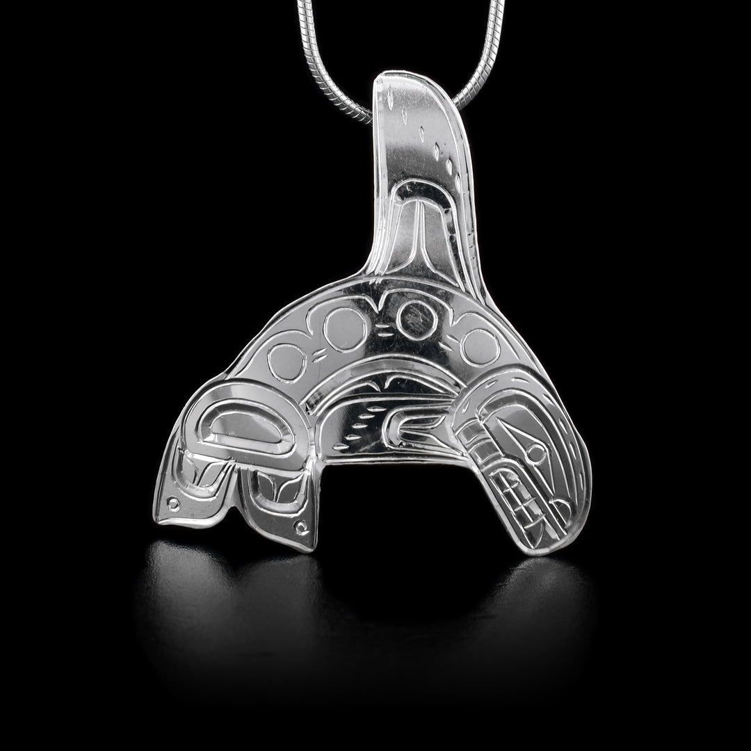 This sterling silver Orca pendant is shaped like the Orca and has engravings depicting the Orca.