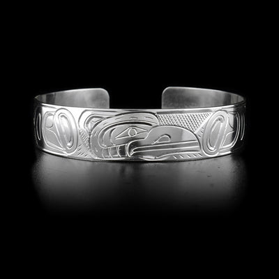 This sterling silver cuff bracelet has a depiction of the Raven carved into its surface.