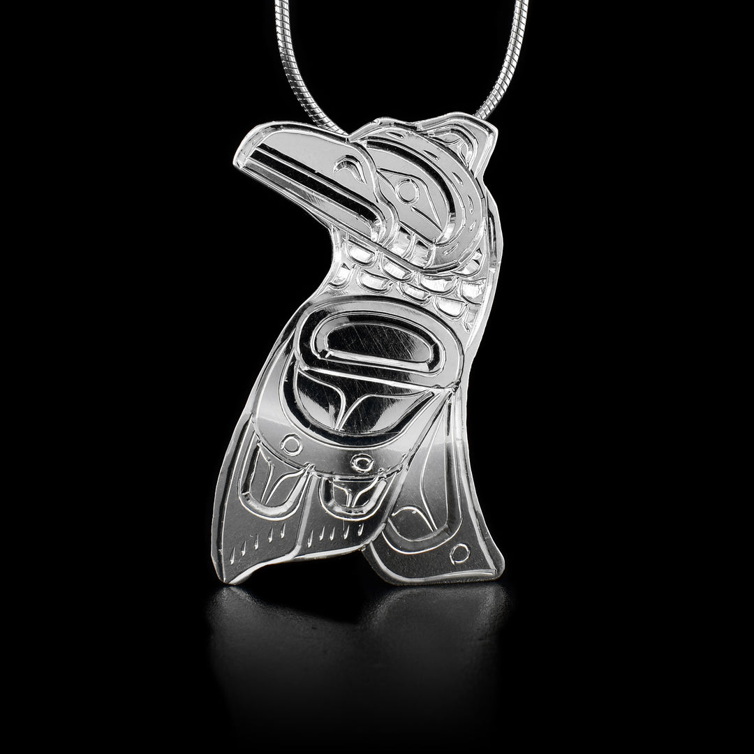 This sterling silver Raven pendant is shaped like the Raven and has engravings that depict the Raven.