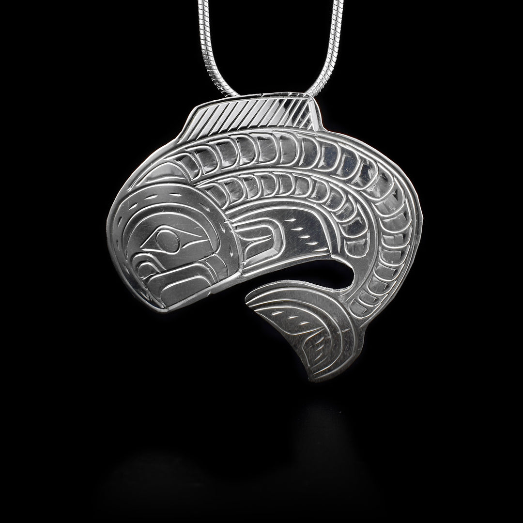 This sterling silver Salmon fish pendant is shaped like the Salmon and has engravings that depict the Salmon.