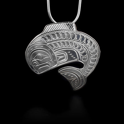 This sterling silver pendant is shaped like the Salmon and has engravings that depict the Salmon.