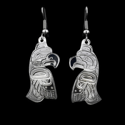 These sterling silver earrings have hooks that have Thunderbird shaped hangs. The Thunderbird has its face and body handcarved on it.