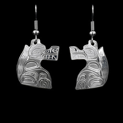 These sterling silver earrings have hooks that have Wolf shaped hangs attached to them. The Wolf has its face and body handcarved on it.