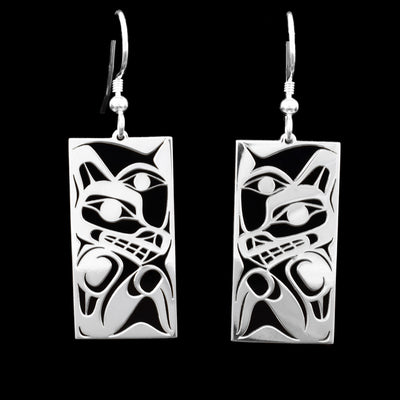 These wolf earrings are rectangular in shape and depict the head of a wolf with its body underneath. Above it are carvings depicting the Moon.