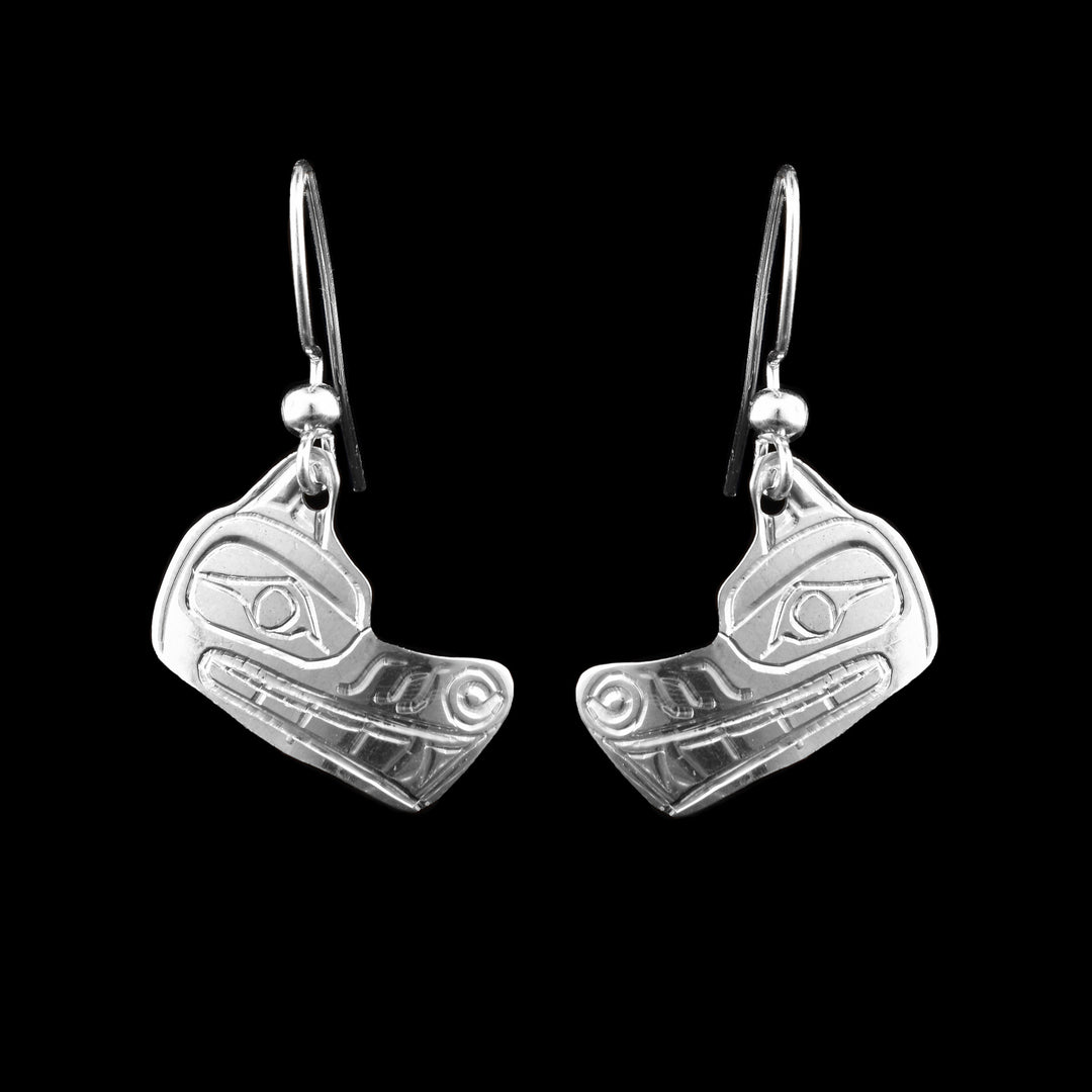 These wolf face shaped sterling silver dangle earrings. From ear to snout the legend of the wolf is carved from the detail in the nose to their eyes.