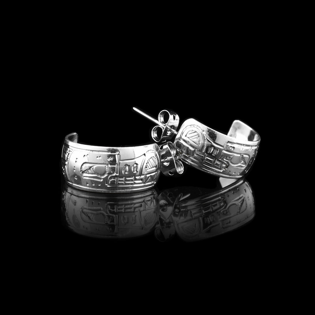 sterling silver wolf half hoop earrings featuring intricate wolf engravings, with the wolf's head facing the stud.