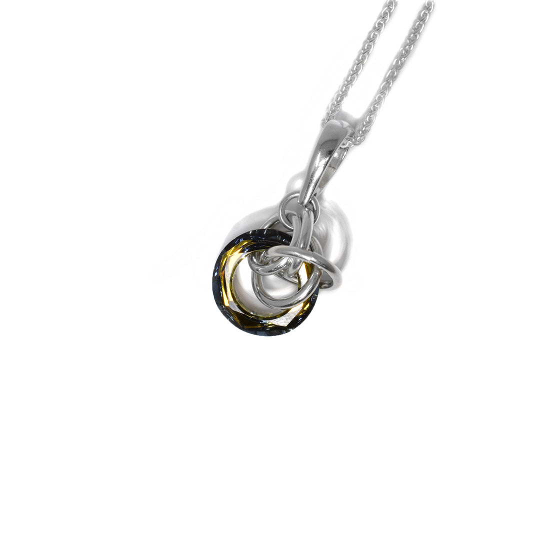 Bronze Swarovski crystal ring with interconnected sterling silver rings woven around and through it. Pendant measures 1.2” x 0.6” including bail.