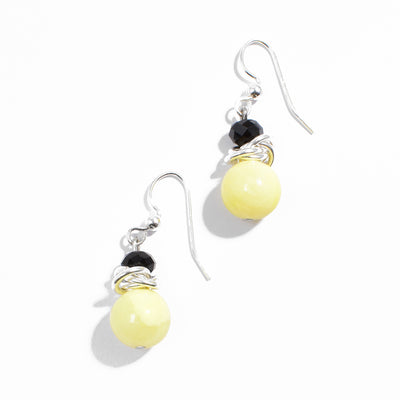 Sterling silver yellow quartzite earrings with interlocking hoops adornments and black crystals.