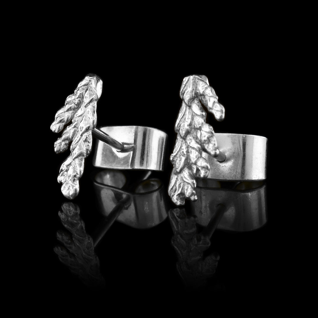 These cedar tree earrings studs are made from sterling silver and depict realistic cedar branch needles.