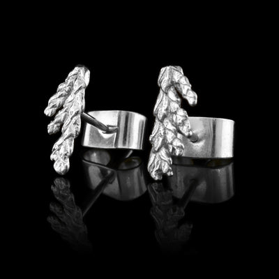 These cedar tree earrings studs are made from sterling silver and depict realistic cedar branch needles.
