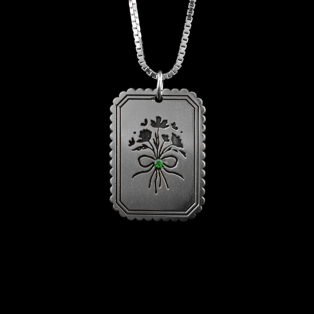 floral pendant necklace, This pendant is in the shape of a postage stamp and in the middle is a etched bouquet of flowers. 