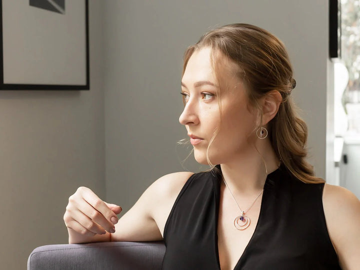 This photo shows the necklace with matching set of earrings on a model. The model is looking to the side.