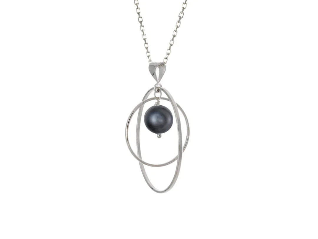 This black pearl necklace has a large sterling silver hoop with a smaller hoop in the middle of it and a sphere shaped black pearl bead in the center of them. All of these pieces are suspended and can orbit around each other.