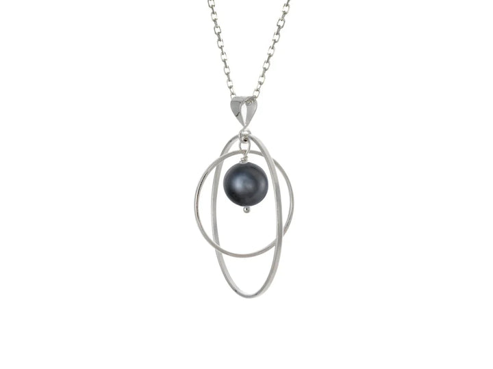 This black pearl necklace has a large sterling silver hoop with a smaller hoop in the middle of it and a sphere shaped black pearl bead in the center of them. All of these pieces are suspended and can orbit around each other.