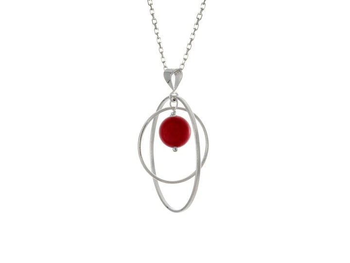 This sea bamboo necklace has a large sterling silver hoop with a smaller hoop in the middle of it and a sphere shaped red, sea bamboo bead in the center of them. All of these pieces are suspended and can orbit around each other.