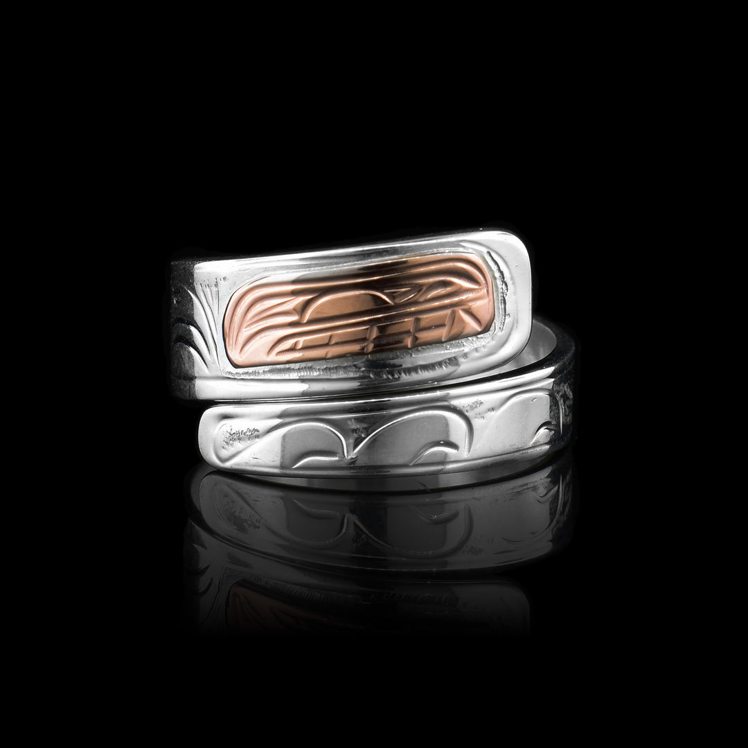 silver and copper orca wrap ring uses sterling silver for the wrap and copper to depict the orcas head at the top of the ring.