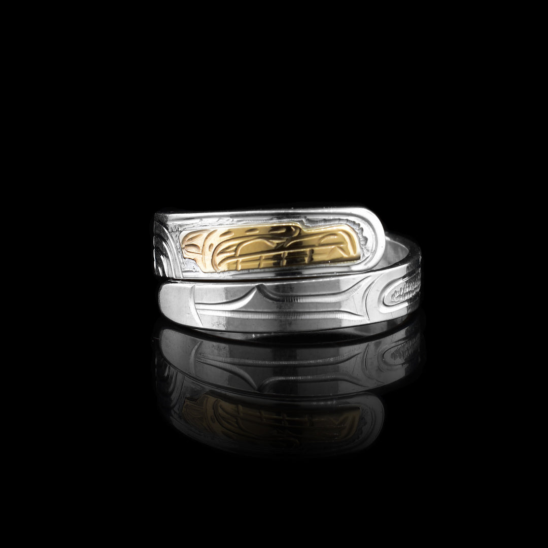 This silver and gold bear wrap ring the bottom of the ring is silver with etching that starts the pattern of the bear legend. The wrap has more detail at the top ending with the gold head of the bear.