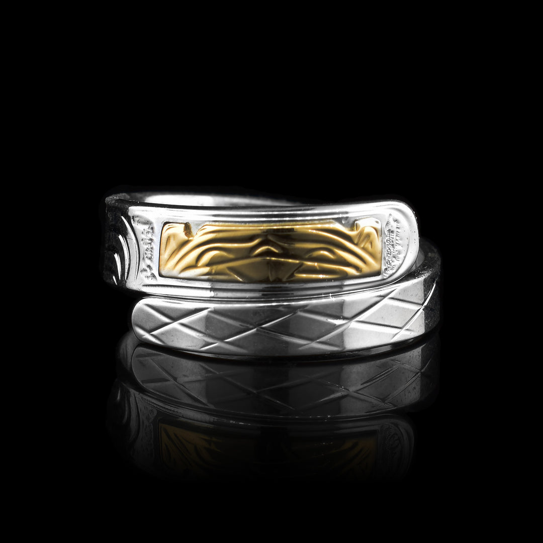 This silver and gold beaver wrap ring this silver wrap ring is hand carved with the legend of the beaver with the head being in gold. It is a beautiful piece of indigenous art.