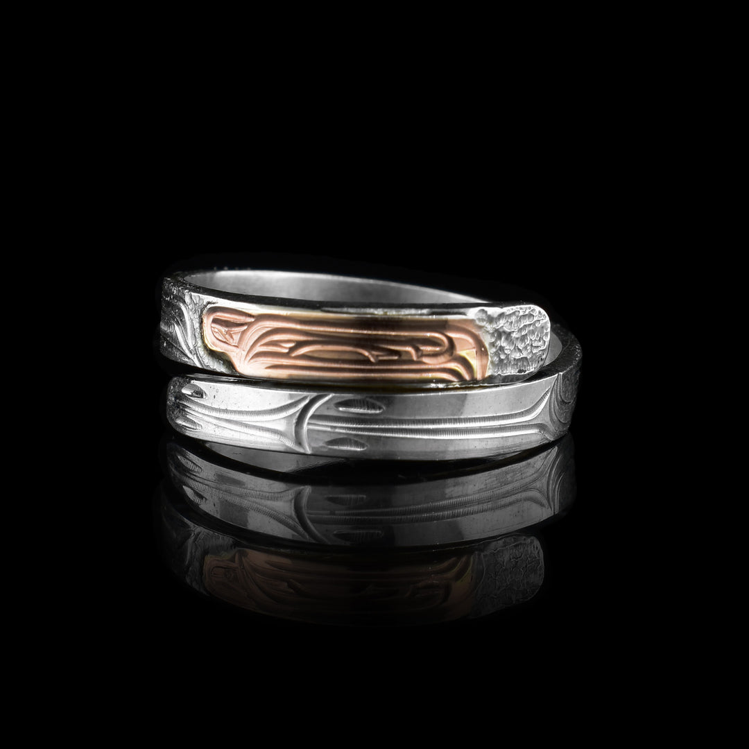 silver and rose gold raven wrap ring made with sterling silver and the ravens head made out of rose gold 