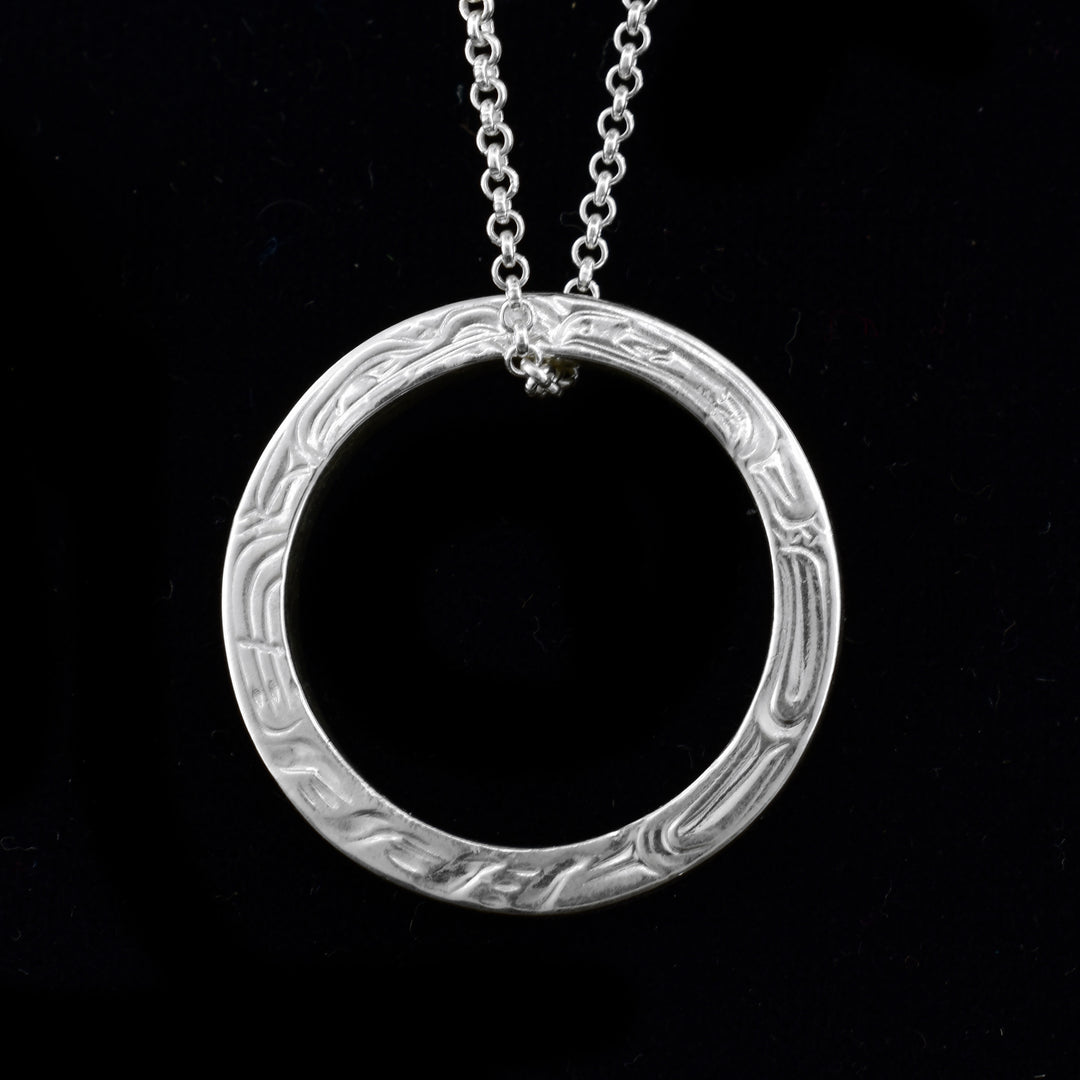 silver wolf and raven ring pendant is a circular pendant with the carvings of the wolf and raven all around. 