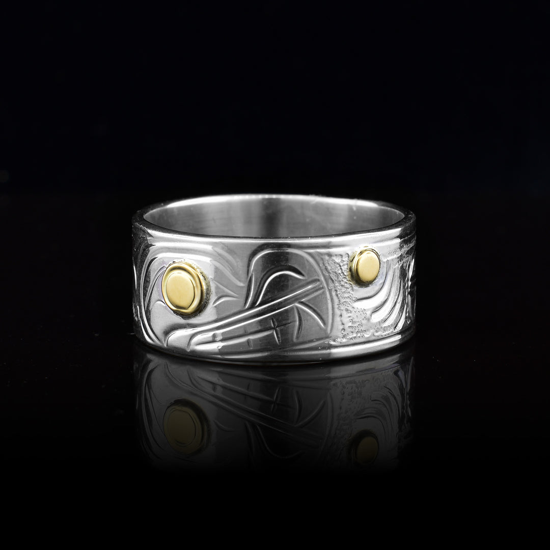 This sterling silver 14k gold wolf and moon band ring is hand carved legend of the wolf and moon on the sterling silver band. The 14k Gold is used for the wolfs eye and the moons center.