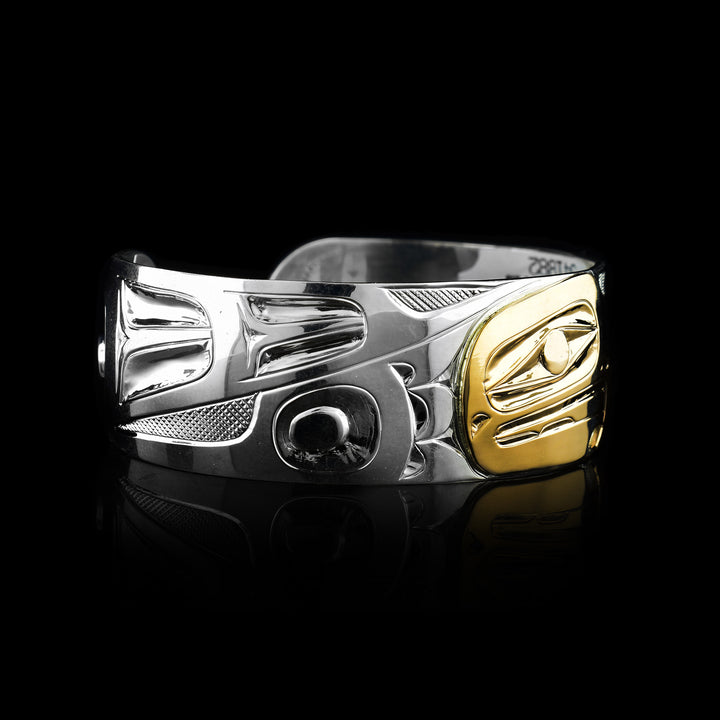 this bracelet is sold at Artina's in Victoria i is 3/4" wide sterling Silver and 14k Gold Eagle Cuff Bracelet. the eagles face is crafted with gold while the remainder of the cuff is made with sterling silver.