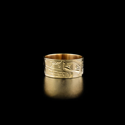 14K Gold 3/8" Double Wolf Ring by Harold Alfred. The design depicts the profile of a wolf's head facing the left. To the left of the first wolf is an identical second wolf upside down. They are connected at their noses. The rest of the ring has been delicately hand carved with intricate designs.