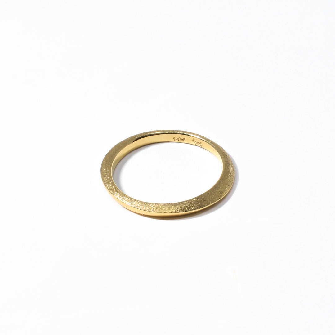 This dainty 14K gold ring is handmade by artist Pamela Lauz.  This ring has a brushed finish on top, giving it its striking texture, and is polished on the bottom. Size 6 is available.