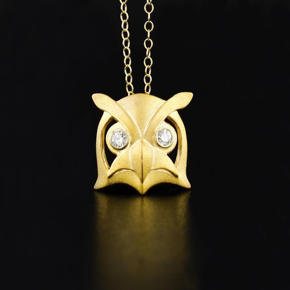 This gold diamond pendant is made from 14K white gold, brushed 14K yellow gold and diamonds. The pendant depicts the face of an owl and the diamonds have been bezel set into white gold for the eyes.