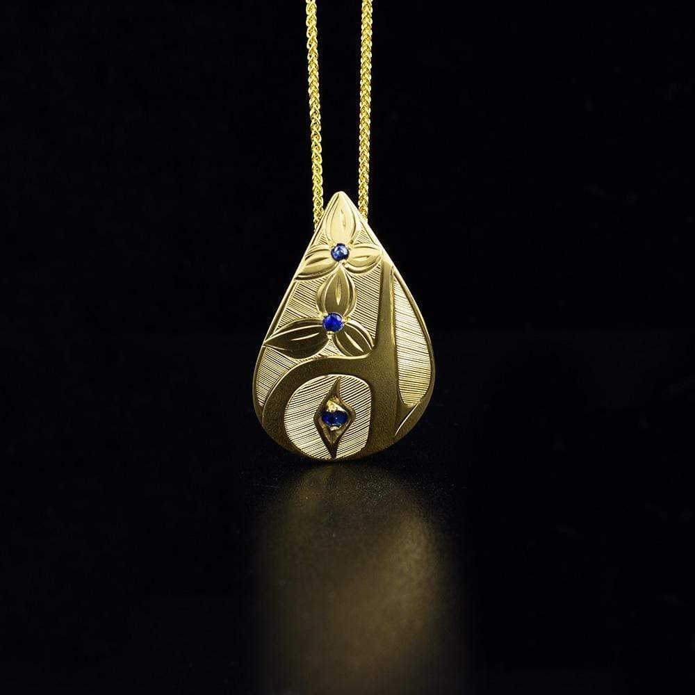 14k gold teardrop hummingbird pendant is hand-carved by Haisla artist Hollie Bartlett.