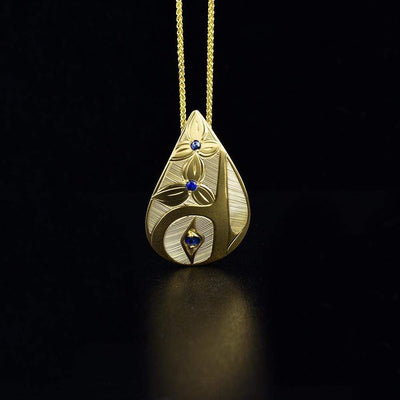 14k gold teardrop hummingbird pendant is hand-carved by Haisla artist Hollie Bartlett.
