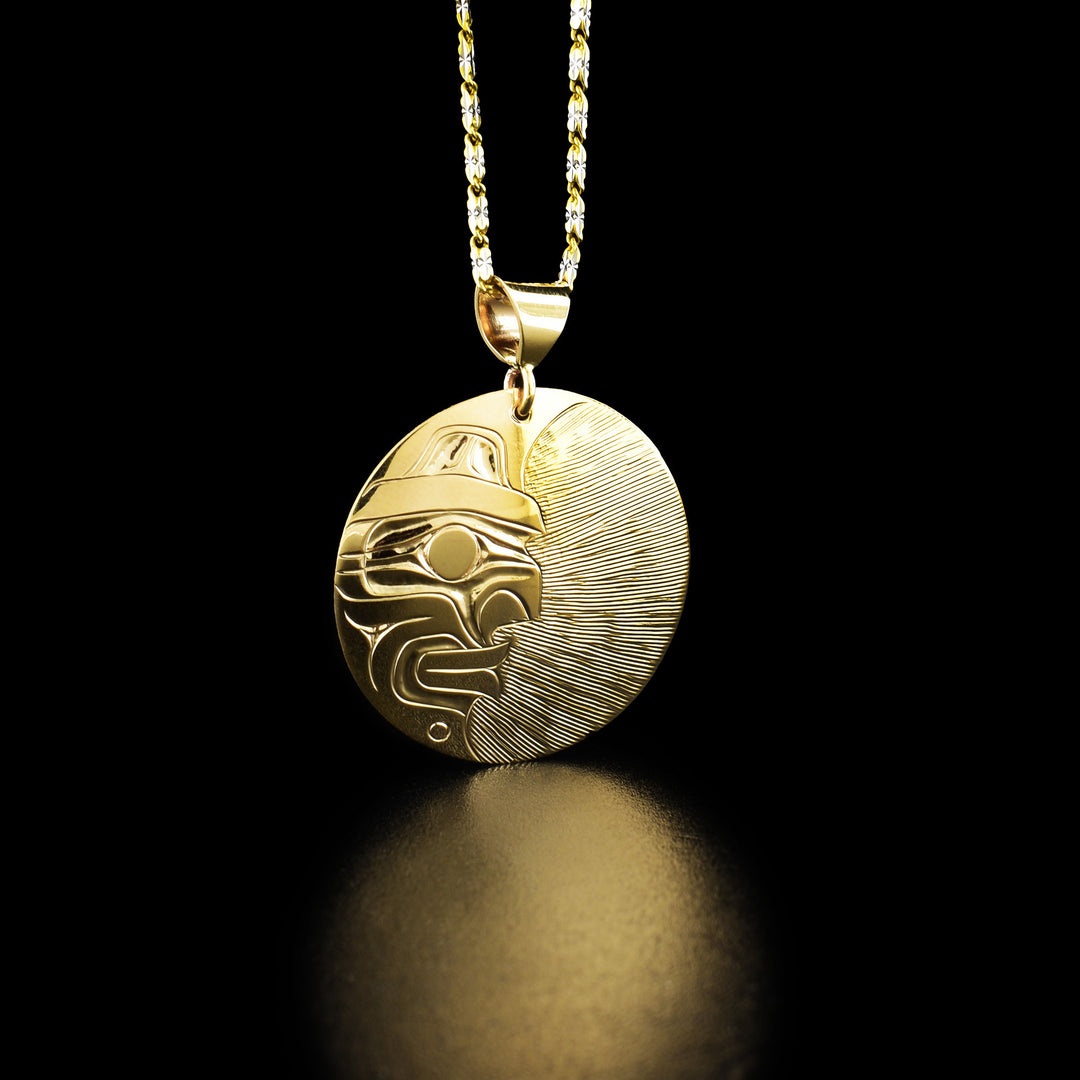 14K Gold Florentine Moon pendant by Harold Alfred. The round pendant has been carved from 14k gold. On the left half of the pendant the artist has hand carved half the face of a moon. On the right half of the pendant the artist has drawn delicate, straight lines going across horizontally to create a soft contrast effect to allow for the moon legend to stand out.