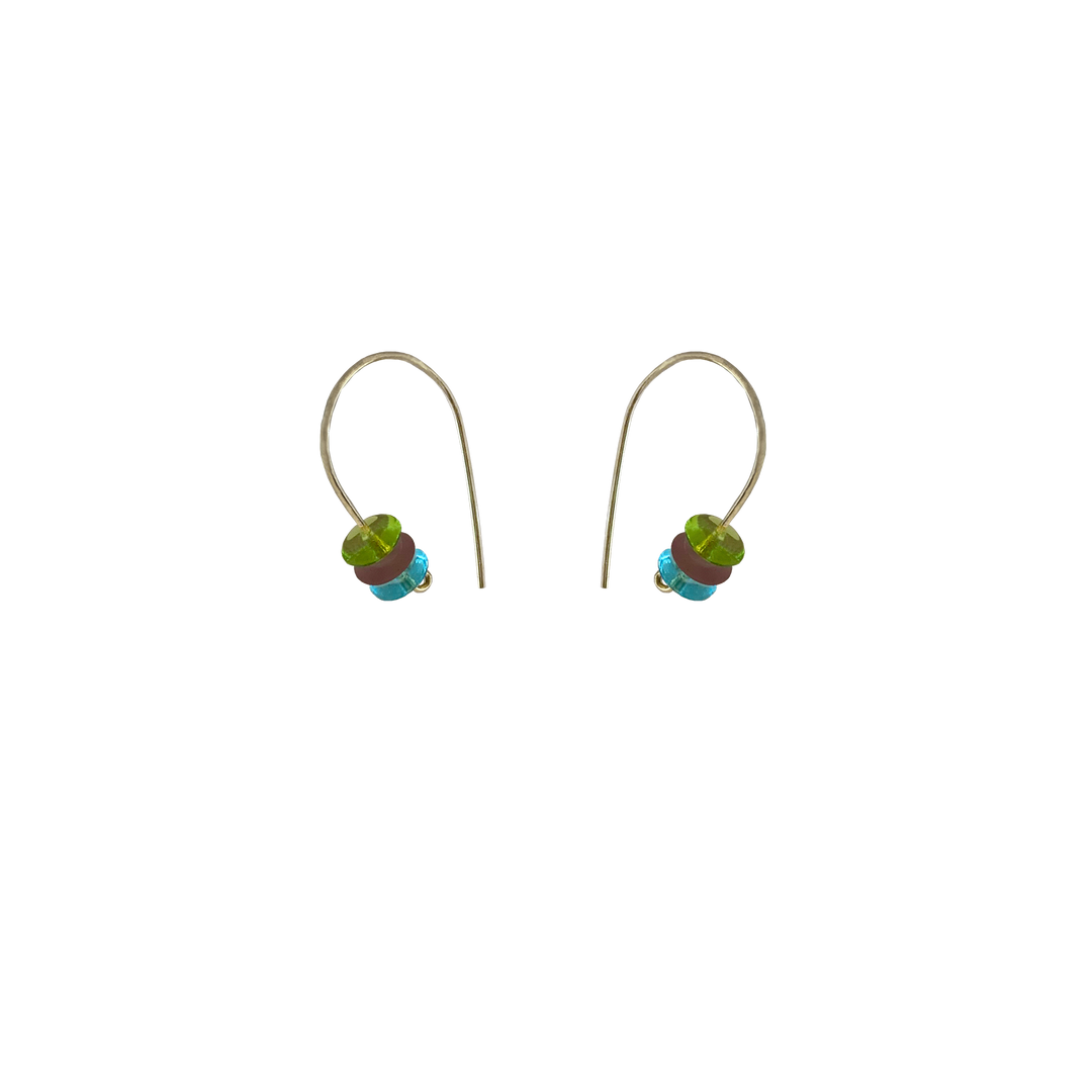 These beaded hoop earrings are made from sterling silver and glass beads. The silver hoops curve below the ear and you can interchangeably add up to three colorful beads to each earring